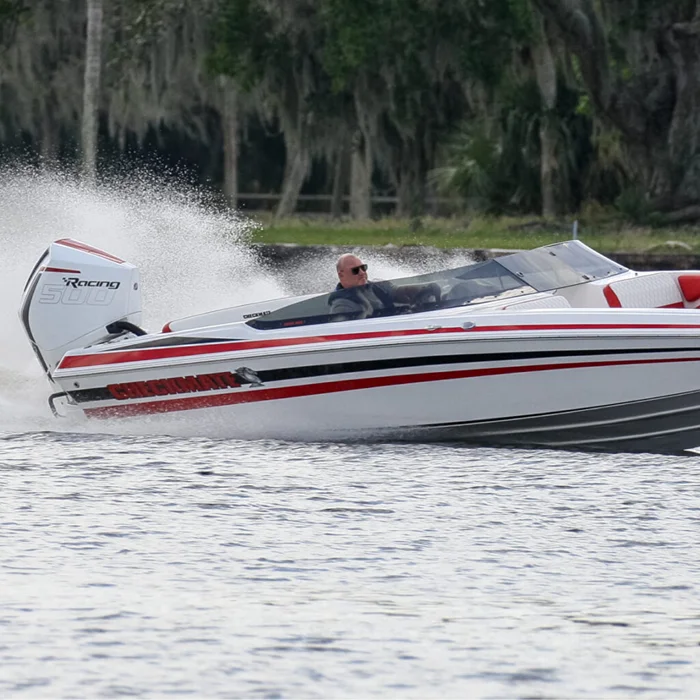 Man driving Checkmate Powerboats 2400 BRX